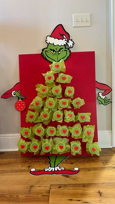 the grinch christmas tree is made out of green gummy balls and red paper