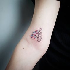 a small tattoo on the arm of a woman