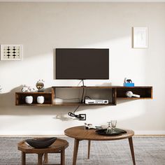 a living room with two tables and a television