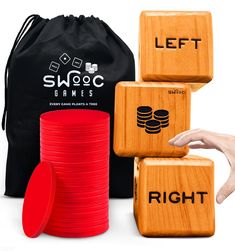 wooden dices with matching red and black plastic discs in front of a drawstring bag