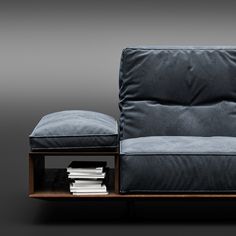 a black couch sitting on top of a wooden shelf