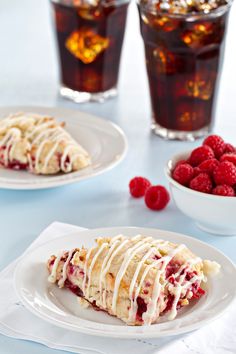 raspberry scones with white icing on plates and glasses of ice tea