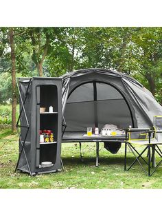 an outdoor tent set up in the grass