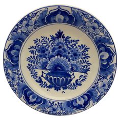 a blue and white plate with flowers on it