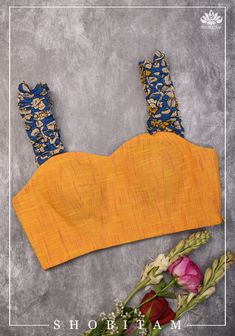 A stylish silhouette and classy and comfortable cotton come together in this blue and yellow sweetheart neck with a gathered frill straps.  This blouse is custom made as per your size. Other designs with or without sleeves are possible in this design, and the pricing would depend on the fabric needed. Please talk to us if you would like this blouse customized in other patterns.  Margins, lining and padding are included. "Time to Ship : 2 weeks"    Note: There may be a slight difference in shade between the actual product and what you see on screen due to variance in screen settings and other factors. Strap Blouse Designs, Sweetheart Neck Blouse, Trending Blouse, Blouses Pattern, Modern Blouse, Sleeveless Blouse Designs, Kalamkari Blouse, House Of Blouse, Modern Dresses