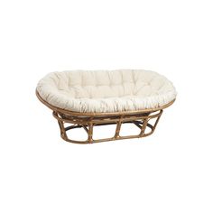 a rattan and wicker dog bed with white fabric on the bottom, in front of a white background