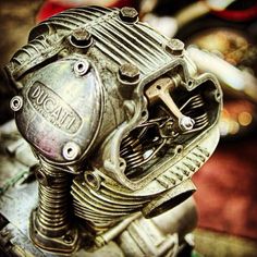 an old motorcycle engine sitting on top of a table