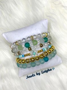 Mix & Match bracelets to build your own set!  Purchase as a set or individually.  Beautiful handcrafted bracelets. All bracelets are one of a kind. Made with high quality glass, acrylic, crystal beads and durable elastic stretchy cord.  ✨One quantity per item.  Size 6-7" (medium) Multiple shades of Blues, Green & Gold Accent Stretchy Bracelets.  1: Glass seed beads w/ Resin flower charm & silver accent beads  2: Glass beads w/ silver beads 3:  4: Glass seed beads w/ Resin flower charm & silver accent beads  5:   6: Acrylic crackle glass beads/ silver spacers 1: Acrylic clear opal beads w/ gold spacer beads  2: Frosted glass bead w/ crystal glass beads 3: Crystal glass beads w/ gold spacer beads  4: Glass seed beads w/ Resin flower charm & gold beads  5: Gold acrylic beads w/ silver spacer Gold Accent Jewelry, Match Bracelets, Shades Of Blue Green, Handcrafted Bracelets, Flower Beads, Stretchy Bracelets, Resin Flowers, Green Flower, Flower Charm