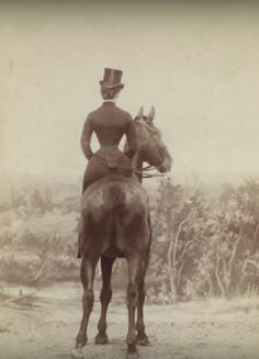 an old photo of a woman on a horse