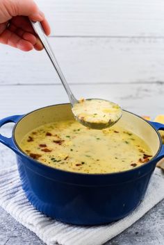 a blue pot filled with soup on top of a white towel