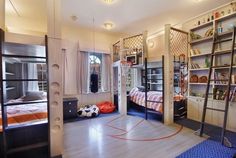 a bedroom with bunk beds and ladders in it