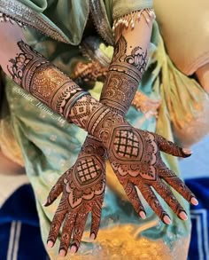 a woman with henna tattoos on her hands