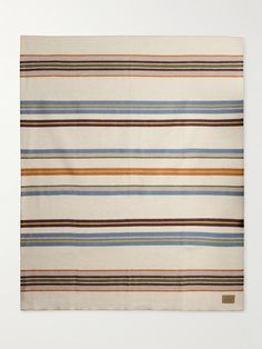 a multicolored striped rug on a white background