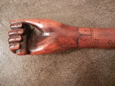 an old wooden hand with writing on it