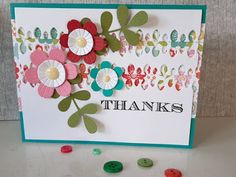 a thank card with buttons and flowers on it