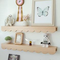 two wooden shelves with pictures and toys on them