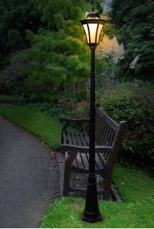 a park bench sitting next to a lamp post