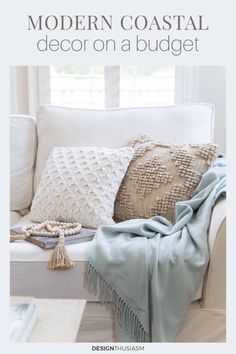 a white couch with some pillows on it and the words modern coastal decor on a budget