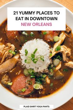 a white bowl filled with meat and rice on top of a wooden table in front of a sign that says 21 yummy places to eat in downtown new orleans