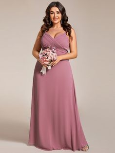 a woman in a long purple dress holding a bouquet