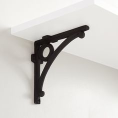 a black shelf bracket on the wall