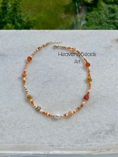 🧡Introducing our Orange Minimalist and Dainty Necklace, featuring a lustrous freshwater pearl centerpiece.     🔮 Flanked by vibrant orange jade and orange agate beads, this necklace radiates elegance and vitality. Gold-plated beads and delicate seed beads add a touch of luxury and intricate detail.      🦢Perfect for adding a subtle pop of color and sophistication to any outfit. HeavenlyBeadsArt🧿 Mixed Bead Necklace, Orange Beaded Necklace, Pearl Necklace With Gold, Mixed Beads Necklace, Pearl Centerpiece, Necklace Orange, Orange Necklace, Orange Agate, Summer Necklace