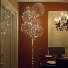 a chandelier hanging from the ceiling next to a dining room table