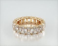 14K Yellow Gold Emerald Cut Diamond Eternity Ring (7 CTW H-I / SI1-SI2). This timeless eternity ring features the boldness and elegant gleam of emerald cut diamonds. A classic, tailored shared prongs setting allows the maximum amount of the diamonds surface to show. Number of diamonds and carat total weight will vary depending on ring size. Emerald Eternity Ring, Ring Upgrade, Eternity Ring Gold, Diamond Eternity Ring, Jewelry Photoshoot, Gold Diamond Wedding Band, Emerald Cut Diamond, Eternity Ring Diamond, Eternity Band Diamond