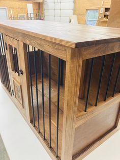 a wooden dog kennel with metal bars on the top and bottom doors, in a store