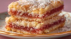 three pieces of dessert sitting on top of a white and orange plate next to each other