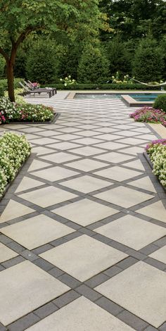 the walkway is lined with flowers and trees