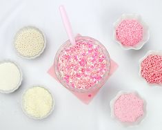 pink and white confetti sprinkles in small bowls next to each other