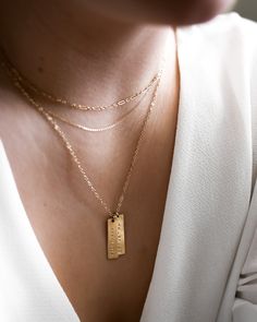 "This vertical bar necklace is a classic, easy to gift piece. From the chain to the pendant, this style is made with 14k gold filled or sterling silver pieces, meaning it is built to last. Personalize this necklace with the names, dates, and special words that mean the most to you! 𝗘𝗮𝘀𝘆 𝗧𝗼 𝗦𝘁𝘆𝗹𝗲, 𝗠𝗮𝗱𝗲 𝗧𝗼 𝗟𝗮𝘀𝘁 Our delicate vertical bar necklaces are elegant, perfect for layering, ready to be personalized with your most special sentiments, moments, and memories! Created to las Name Tag Necklace, Necklace With Kids Names, Names Necklace, Bar Necklaces, Vertical Bar Necklace, Vertical Bar, Kids Names, Choker Style, Silver Bars