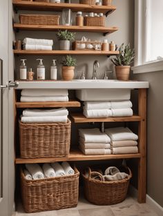 an organized bathroom with baskets and towels