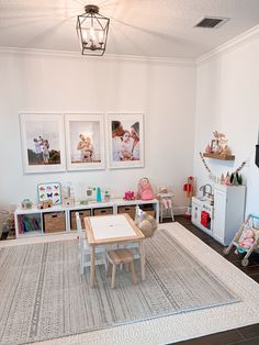 a child's playroom with toys and pictures on the wall, including a baby crib