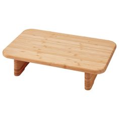 a small wooden table sitting on top of a white floor