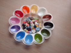 a bowl filled with lots of different colored paints