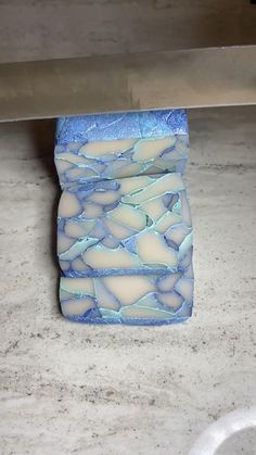 a blue and white vase sitting on top of a counter