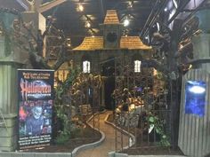 the entrance to an amusement park that is decorated with halloween decorations and fake pumpkins