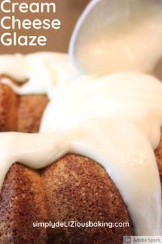 cream cheese glaze is being drizzled on top of a bundt cake