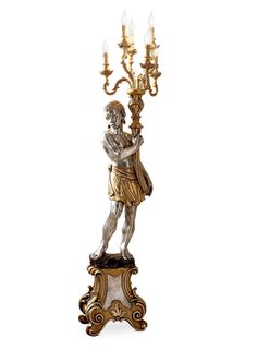 a bronze statue holding a candelabra with four candles