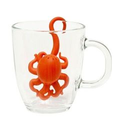 an orange octopus in a glass cup on a white background