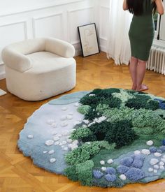 a woman standing in front of a living room rug with trees and bushes on it