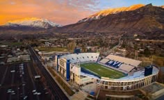 an aerial view of the football stadium with mountains in the background