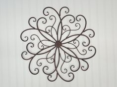 a metal wall decoration with swirls on it