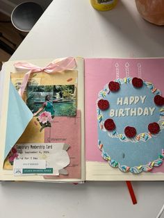 an open birthday card book sitting on top of a table