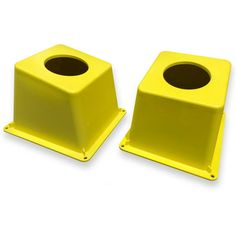 two yellow plastic stools with holes in the middle and one has a black hole at the top