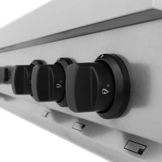 a row of black and white switches on a wall