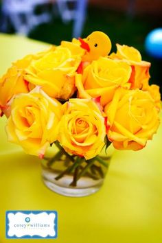 a vase filled with yellow roses on top of a table