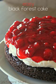 a close up of a cake on a plate with white frosting and red sauce